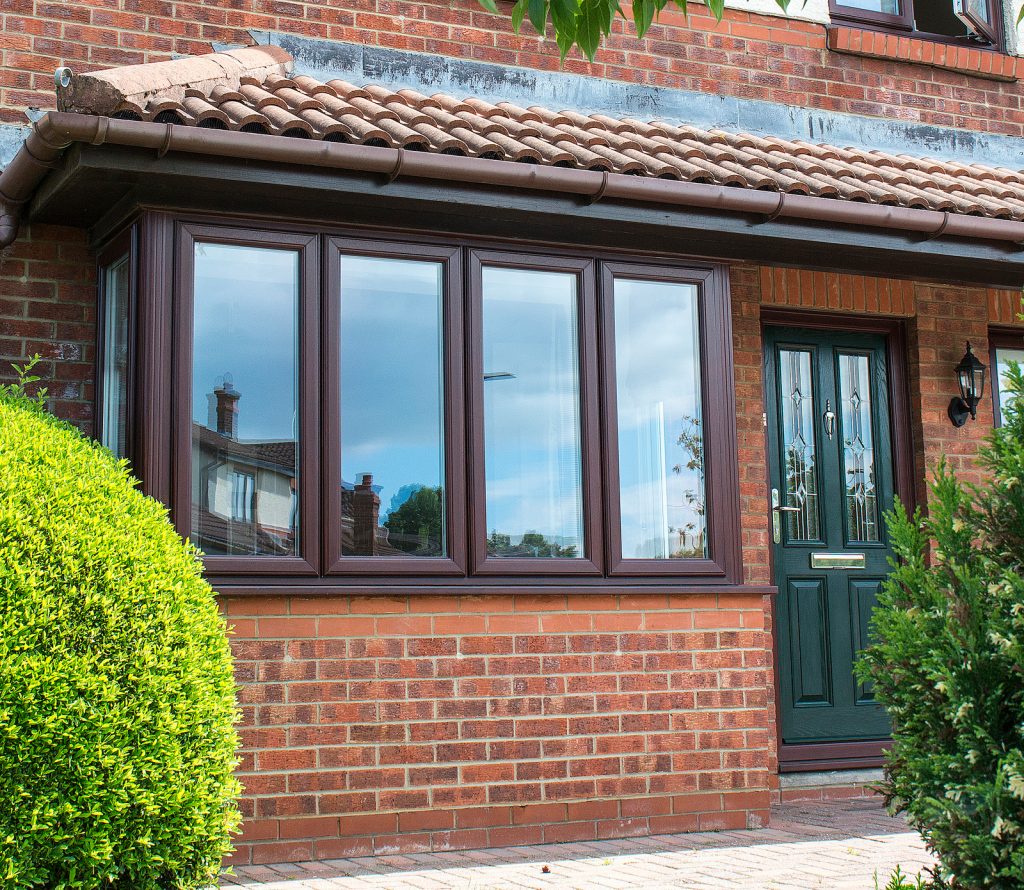 brown upvc bay window with green composite door