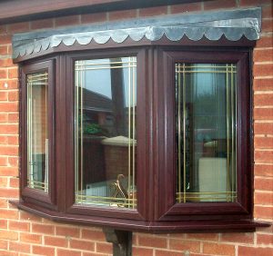 rosewood PVCu bay window with gold lead