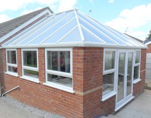 Conservatory with large glass roof and patio doors