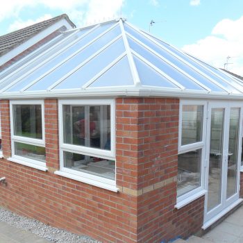 Conservatory with large glass roof and patio doors
