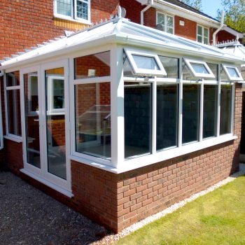 Conservatory with a row of white upvc windows