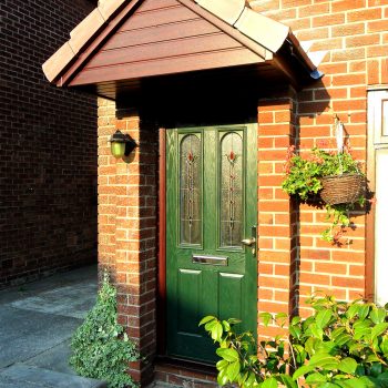 Green composite door with oak upvc door frame and canopy