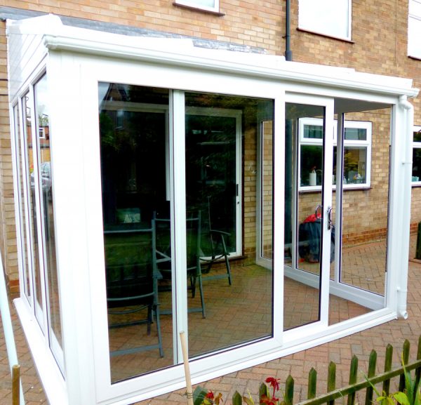 white patio doors opening to a sunroom