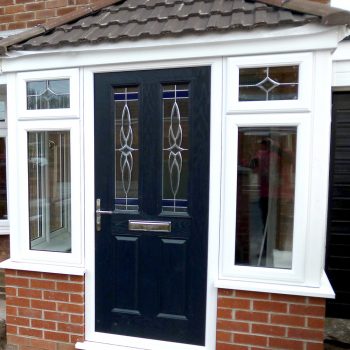 white upvc porch with a blue composite door and tiled roof