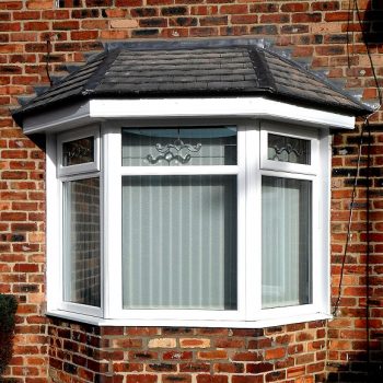 Bay Glass window with white upvc finish and decorative glass